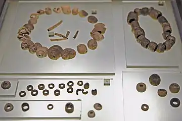 Coquillages perforés, perles de calcaire et de variscite. Tumulus A, niveau supérieur, IVe millénaire.