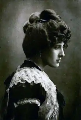 Photo en noir et blanc d'une femme élégante présentée en buste par son profil droit.