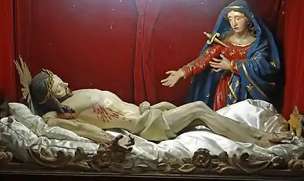 Gisant avec la Vierge dont le chœur est percé par un poignard.