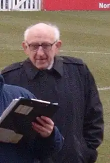 Norman Wilkinson standing on a grass field