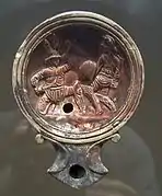Lampe à huile représentant deux gladiateurs combattant