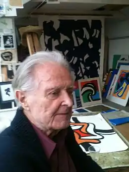 Olle Langert parmi ses œuvres, dans son atelier, en 2014