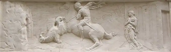 Bas-relief en pierre d'un chevalier tuant un dragon devant une princesse