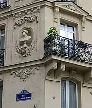 Médaillon d'Alexandre Dumas à l'angle de la rue et du boulevard Voltaire.