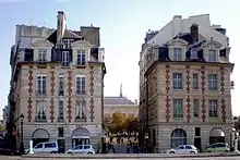 Nos 13 et 15, place du Pont-Neuf, situées de part et d'autre de la rue Henri-Robert menant à la place Dauphine.