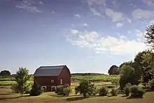 Une ferme pastorale avec un hangar agricole rouge typique, situé au nord du Michigan, aux États-Unis.