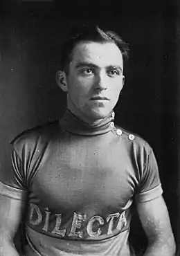 Portrait en noir et blanc d'un cycliste avec un maillot portant l'inscription Dilecta.