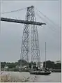 Pen Duick VI remonte la Charente sous le pont du Martrou - Rochefort France, le 17 août 2016.