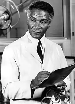 Percy Rodriguez(Dr Harry Miles)