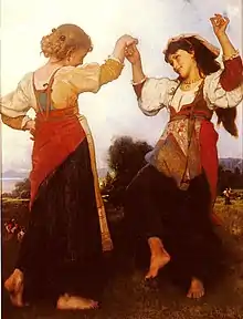 Image de deux femmes en tenues multicolores dansant.