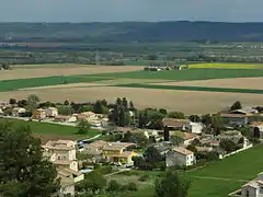 Un des reliefs de la commune : la plaine de la Durance, enserrée entre les collines de Corbières (derrière le photographe) et le plateau de Valensole (au fond).