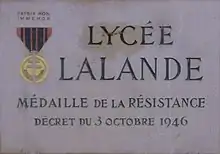 Sur une plaque à l'entrée du lycée Lalande à Bourg-en-Bresse.