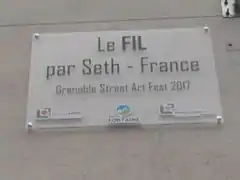 Plaque sous le fresque de Seth, à Fontaine, apposée en 2017.