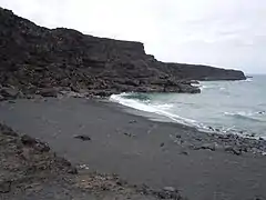 Plage de gravier noir.