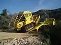 Tracteur chenille sur porte-char après réalisation d'une zone d'appui en Forêt Domaniale de la Sainte-Baume en 2005.