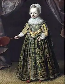 Portrait of a little girl holding av battledore and shuttlecock.