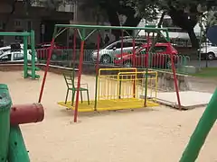 Balançoire en position debout avec chaise pour personne surveillante sur plateforme, Brésil.