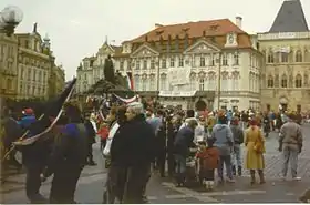 Photographie d'une manifestation de personnes sur une place de Prague