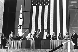 Photographie en couleur de l'équipage d'Apollo 11 lors d'un discours présidentiel.