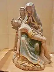 Saint-Goazec(chapelle du manoir de Trévarez) : Vierge de Pitié priant devant le corps du Christ, accompagnée de saint Jean l'Apôtre.