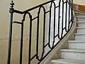 Rampe en fer forgé de l'escalier.