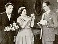 Image tirée du film Red Hot Romance (1922) (May Collins est à-côté de Basil Sydney - à gauche - et d'un acteur non identifié.