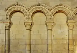 Arcatures avec beakheads dans l'église Saint-Ouen de Rots.