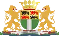 blason constitué d'un drapeau vert et blanc et de quatre lions en miniature encadré par deux lions de part et d'autre et surmonté par une couronne jaune