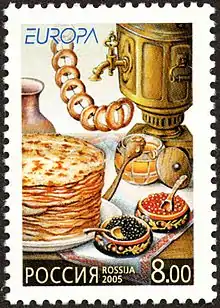 Un timbre représentant tous les ingrédients d’une dégustation de thé, avec des crêpes, du miel et des gâteaux.