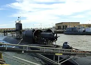 Un sous-marin de poche SEAL Delivery Vehicle (en) en chargement dans la valise sèche du sous-marin américain USS Dallas de la classe Los Angeles.