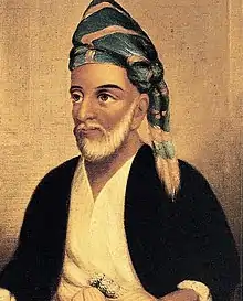 Portrait d'un homme barbu portant un turban ou un foulard.