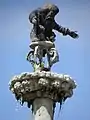 Saint-Jean-du-Doigt : fontaine monumentale (1691), Dieu le Père bénissant le baptême de son Fils.