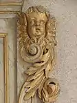 Angelot et volutes du retable sud.