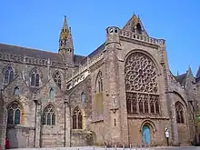 Photographie d'un bras de transept d'église avec une grande rose