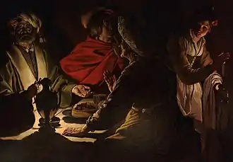 Peinture mettant en scène quatre personnes dans le clair-obscur autour d'une table.