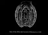 Empreinte blanche sur fond noir d'un sceau médiéval représentant une Vierge trônant avec le Christ enfant sur les genoux.