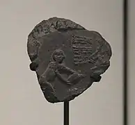 Bulle d'argile avec empreinte de scellement représentant une scène d'engrangement du grain, Suse II, Uruk récent. Musée du Louvre.