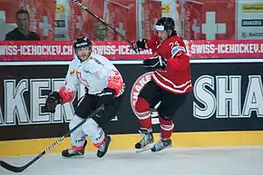 Photographie couleur de Blindenbacher, à gauche, avec l'équipe de Suisse, face au Canadien Jamie Benn à droite