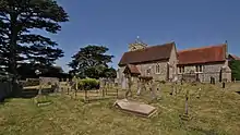 exterior of church and churchyard with residential building to the left