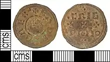 Photo des deux faces d'une pièce de monnaie corrodée portant des inscriptions en majuscules et de petites croix.