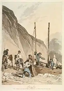 Hommes chargeant des marchandises sur un petit bateau accosté sur la plage.
