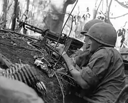 Deux soldats américains, un mitrailleur et son pourvoyeur, utilisant une Saco M60 lors de la guerre du Viêt Nam (1966).