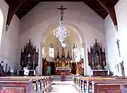 Vue intérieure de la nef vers le chœur et les autels