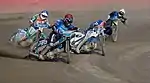 Pilotes de Speedway dans une courbe