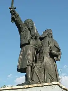 Le Soulèvement de Takovo par Petar Ubavkić, à Takovo, dans l'ensemble commémoratif du Takovski grm. Il représente le prince Miloš (avec un sabre dans la main droite) et le métropolite Melentije