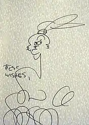 dessin rapide au crayon noir d'un seul trait où l'on devine la tête du lapin. Le dessin est accompagné d'u la mention en anglais "best wishes" et de la signature de l'auteur.