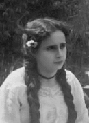 Photo en noir et blanc d'un buste d'une femme aux cheveux longs coiffés avec deux tresses