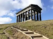 Long wooden steps leading up a hill to Penshaw Monument