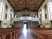 Vue intérieure de la nef vers la tribune d'orgue.