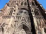 Sur les contreforts, les statues sont placées dans des niches à baldaquin dont les dais élancés sont couronnés d'un oiseau (cigogne ou grue) ou de pinacles, cathédrale Notre-Dame de Strasbourg.